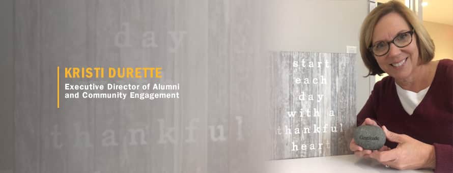 Kristi Durette holding a small stone and the text Kristi Durette, Executive Director of Alumni and Community Engagement.