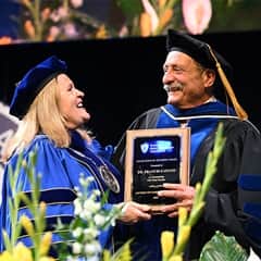 Lisa Marsh Ryerson, SNHU president, left, with Dr. Francis Catano, an Excellence in Teaching Award recipient, right.