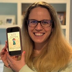 Dr. Lyndsay Goss, a director of continuing professional development in nursing, holding "The Briar Club" by Kate Quinn.