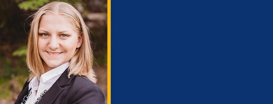 Alexis Gerst to the left of a blue-filled block