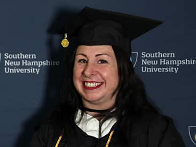 Melissa Honings, who earned her bachelor's in psychology from SNHU in 2023, wearing her cap and gown.