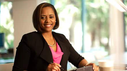 Workplace professional sitting at a table and smiling