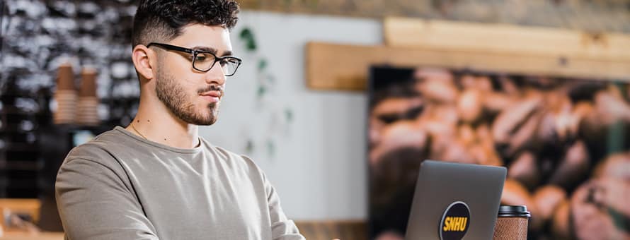 Naeem Jaraysi using a laptop to take online college courses.