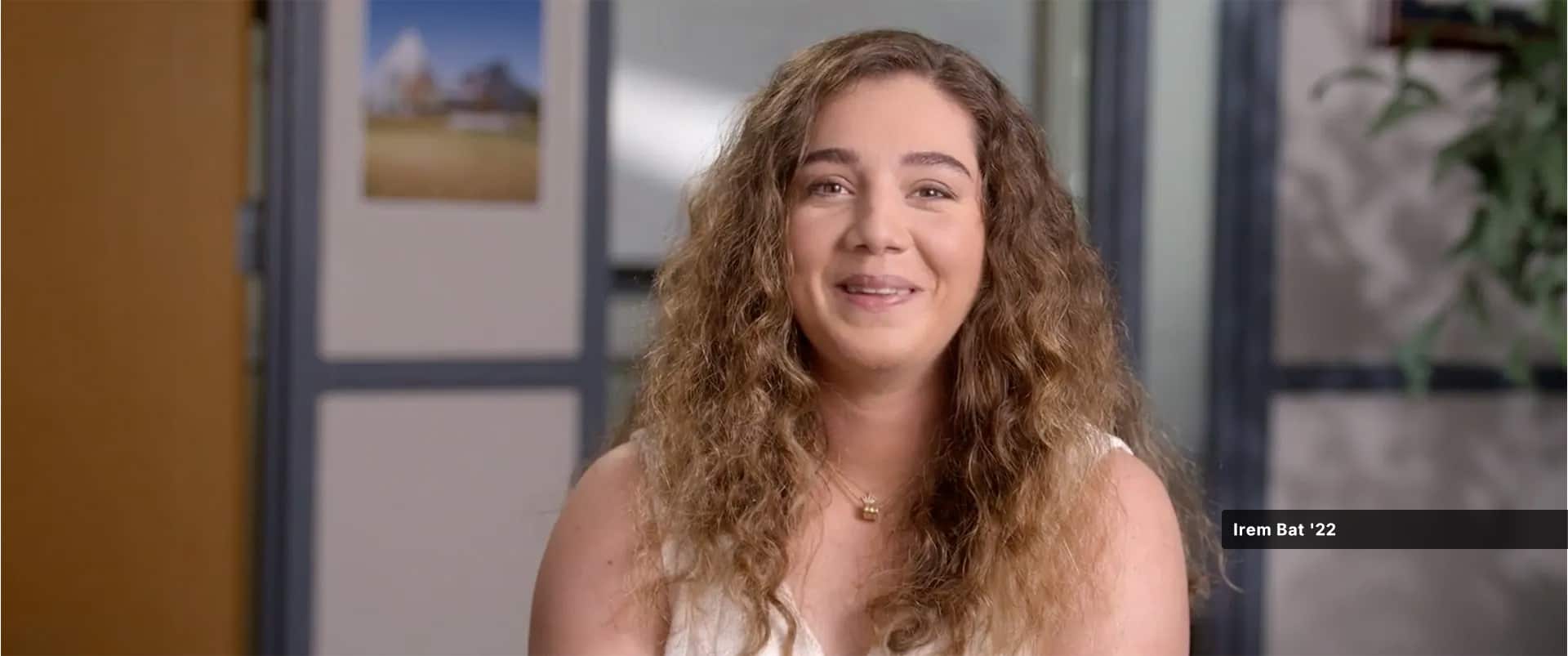 Irem Bat, who earned her master's in IT from SNHU in 2022, wearing a tank top and gold necklace.