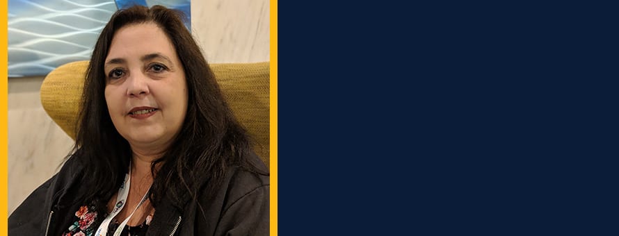 Norma DePriest to the left of a block of ink blue color.