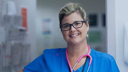 2017 SNHU online RN to BSN degree graduate Kristina Libby wearing nursing scrubs and a stethoscope.