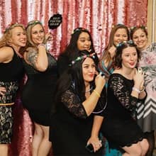 Military spouse attendees posing and holding signs at the Operation Homefront event