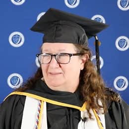 Pamela Judd standing in her SNHU cap and gown