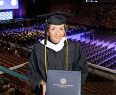 Camille MacIsaac dressed in a graduation cap and gown at her SNHU Commencement ceremony. 