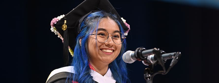 Kayleigh An Philip, an SNHU graduate with her BA in communication speaking at spring 2024 Commencement