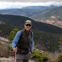 Ben Cole standing on a mountain