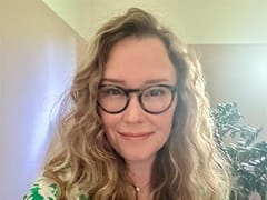 Samantha Sherwood, who earned her bachelor's in environmental science from SNHU in 2024, wearing a green and white shirt and eyeglasses.