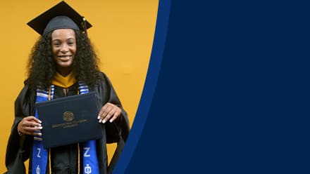 Shiqueta Dixon, a 2025 master's in healthcare administration graduate from SNHU, wearing a cap and gown and holding her diploma.