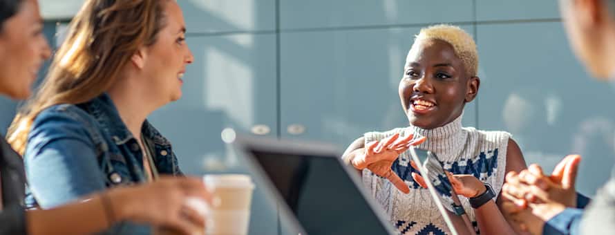 A group of business professionals discussing why they should get an MBA