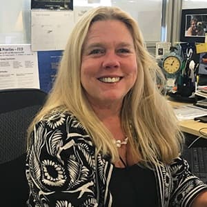 Sloan Kelly, SNHU Associate Dean of Fine and Applied Arts, sitting in an office setting.