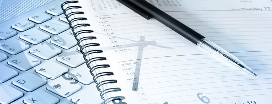 a shadow of a clock over a day planner journal