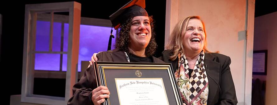 SNHU graduate Stephanie Gould holding her diploma with SNHU's executive vice president and university provost, Lisa Marsh Ryerson