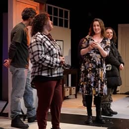 SNHU graduate Stephanie Gould on stage with her cast members