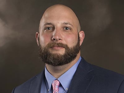 Vince Farrell, who earned his BS in Criminal Justice with a concentration in Homeland Security from SNHU in 2021, wearing a suit and tie.