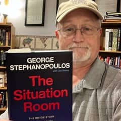 Joseph Wellington, an academic advisor at SNHU, holding a book