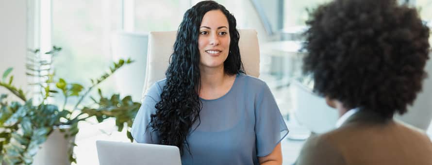 Two business professionals discussing what degree is needed for human resources