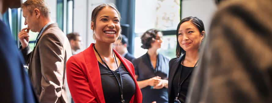 Alumni talking to each other at a networking event