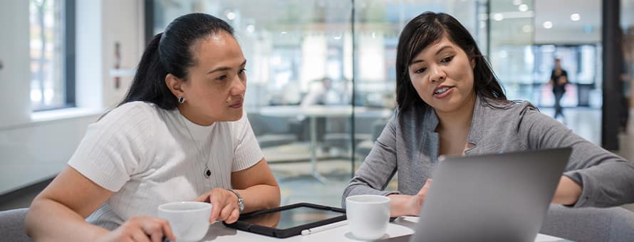 Two people looking at a laptop learning about what a CPA is