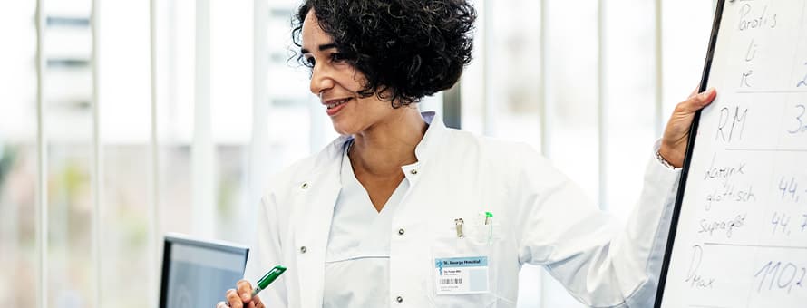 A public health professional holding a marker, describing what epidemiology is
