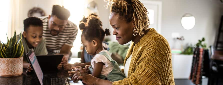 A woman surrounded by family researching what a general studies degree is