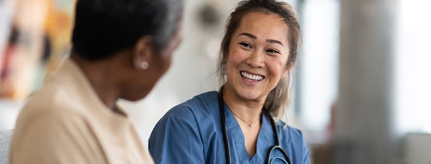 A nurse smiles and explains to another nurse what is an MSN degree.