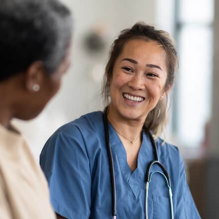 A nurse smiles and explains to another nurse what is an MSN degree.