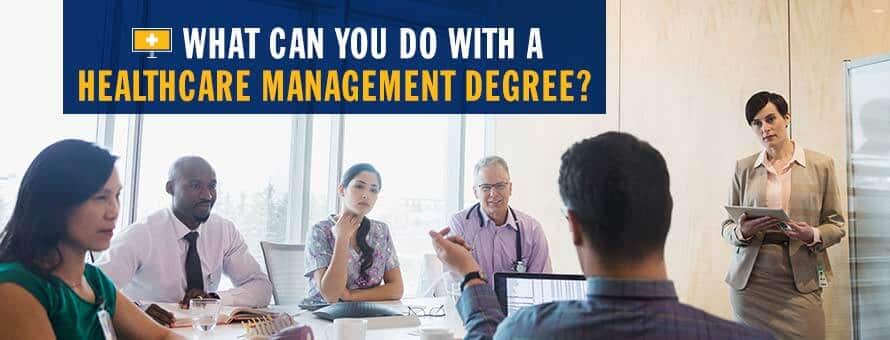 A person with a healthcare management degree in a conference room, leading a meeting with 5 other healthcare professions
