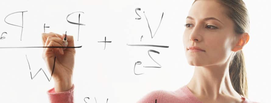 A person with a degree in math, writing equations on a dry erase board.