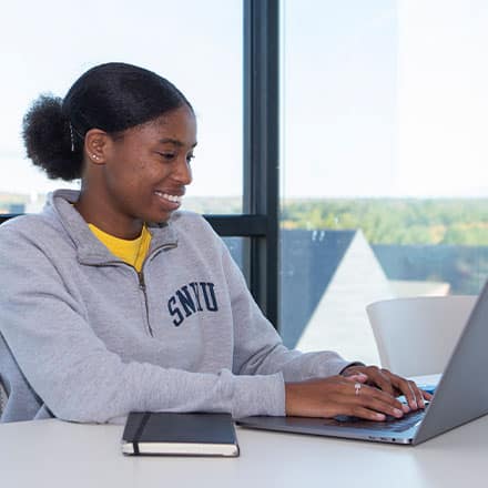 A student studying for her general education classes in college.