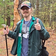 William Gorman, an online student at SNHU and Global Days of Service project leader, outdoors and surrounded by trees.