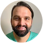 Tyler Crouch, an SNHU graduate, military veteran and Virginia resident, wearing light green scrubs